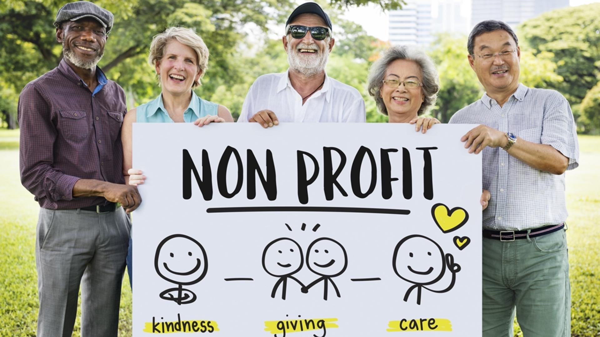 group people holding non profit sign