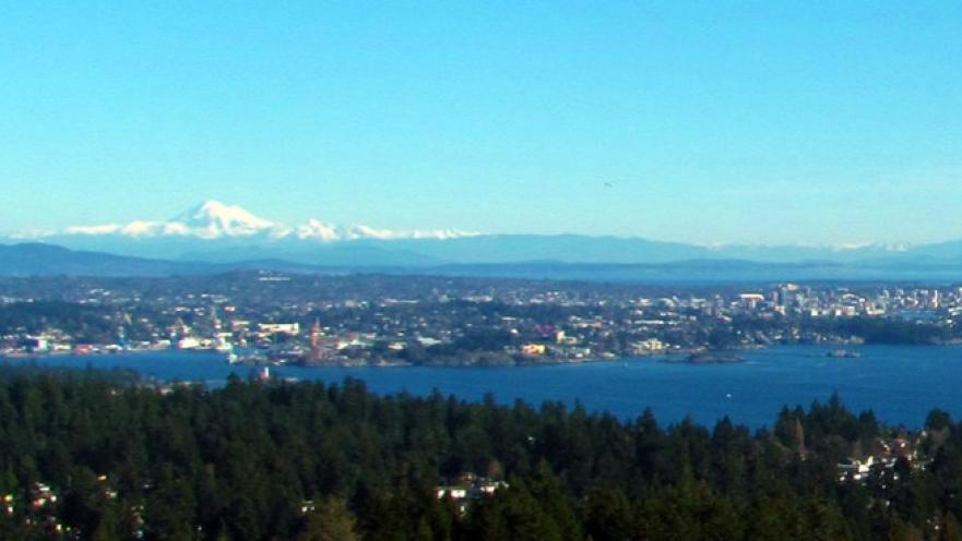 Panorama of coastal town. There are some mountains in the background.