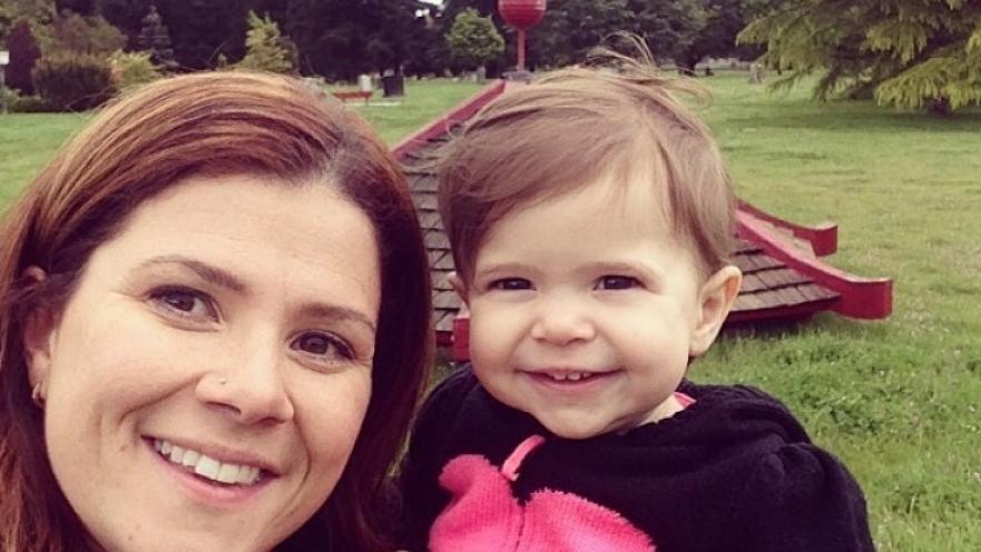 Selfie of woman with child. The child is wearing a black shirt with a large pink heart on it.