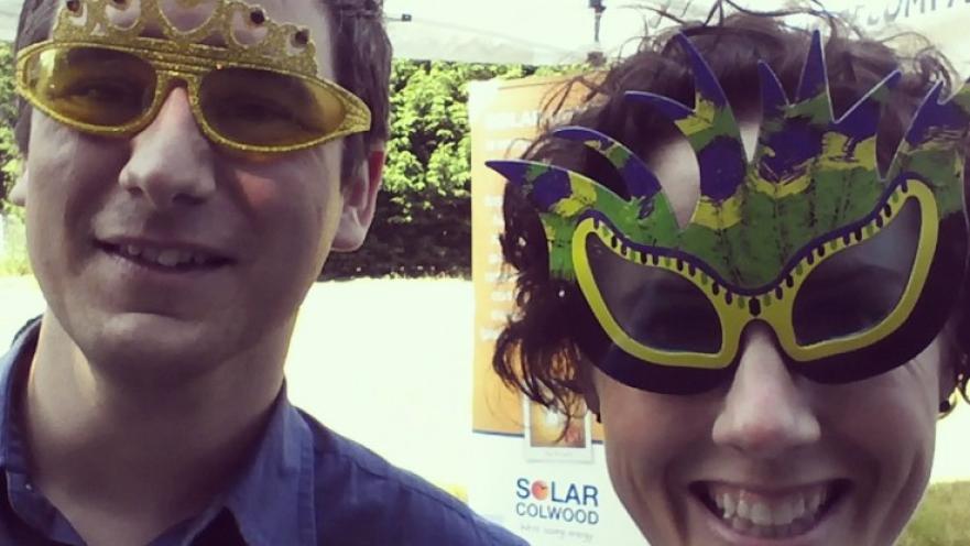 Selfie of man and woman wearing novelty sunglasses. The subjects are smiling.