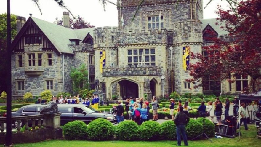 Film production in action at Hatley Castle. There is an old stone castle in the background. 