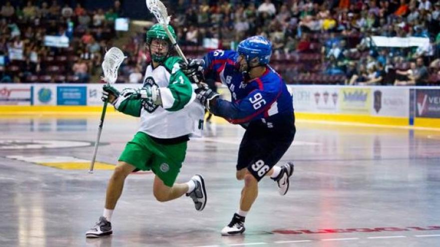 Lacrosse game being played in an arena. 