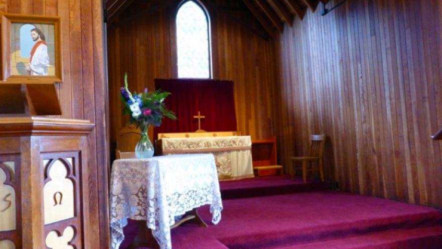 Interior of church. There is an altar in the background.