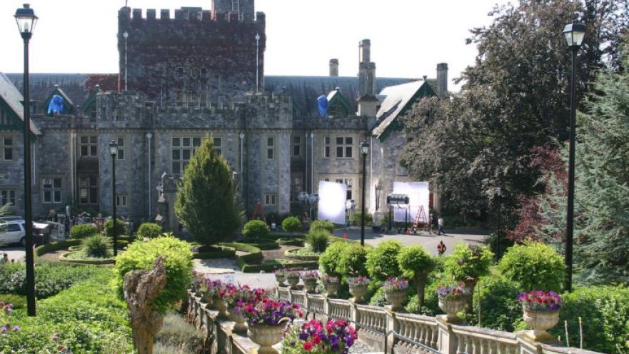 Exterior of Hatley Castle. There is a large stone castle in the background.