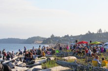 crowd of people relaxing on beach chairs while live band plays music