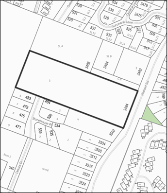 Black and white map highlighting a rectangular plot of land, surrounded by various numbered plots and residential areas.