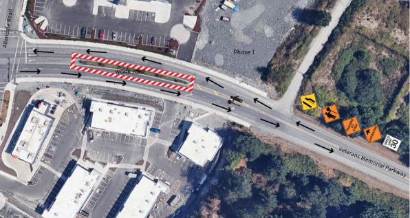 Aerial view of Veterans Memorial Parkway with clearly marked work zones and traffic signs, indicating road construction phases and traffic flow.