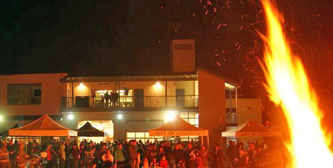 Nighttime event with a large bonfire and people gathered at the City of Colwood.