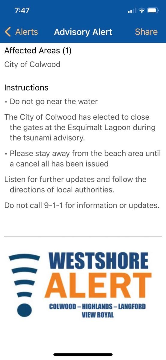 Advisory alert on a mobile device for the City of Colwood, instructing residents to avoid the water during a tsunami advisory.